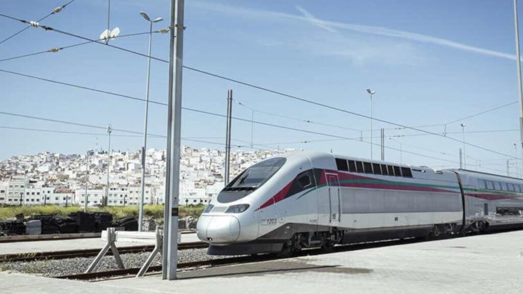 Al Boraq, Morocco's high-speed train, stationed with the backdrop of a densely packed Moroccan city.
