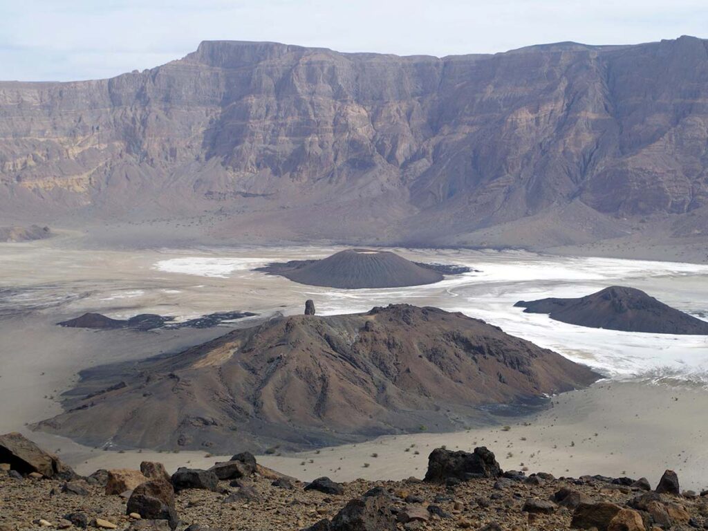 Scenic view of Emi Koussi volcano in Chad, the highest peak in the Sahara Desert, surrounded by rugged terrain and volcanic cones.